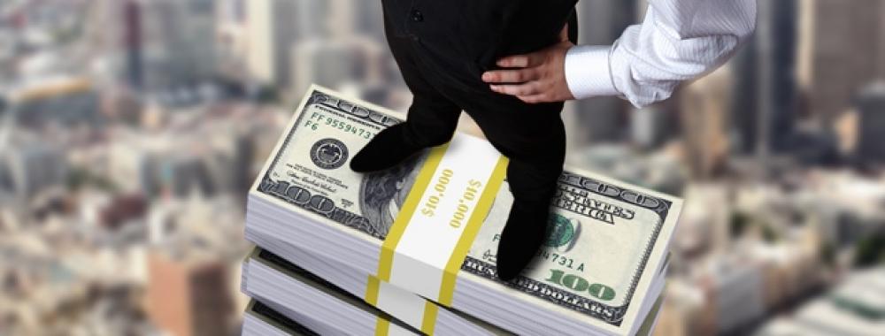 Young businessman with money symbols 2.jpg